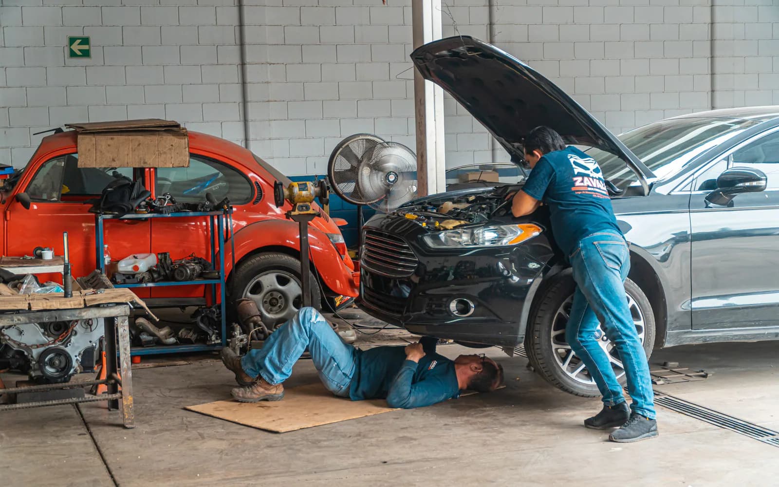 An independent repair shop owner discussing a vehicle with a customer
