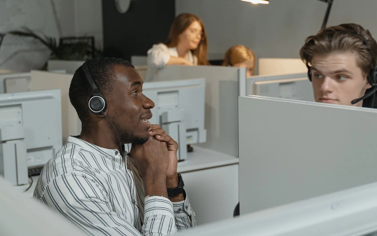 Customer support professionals coordinating while wearing headsets