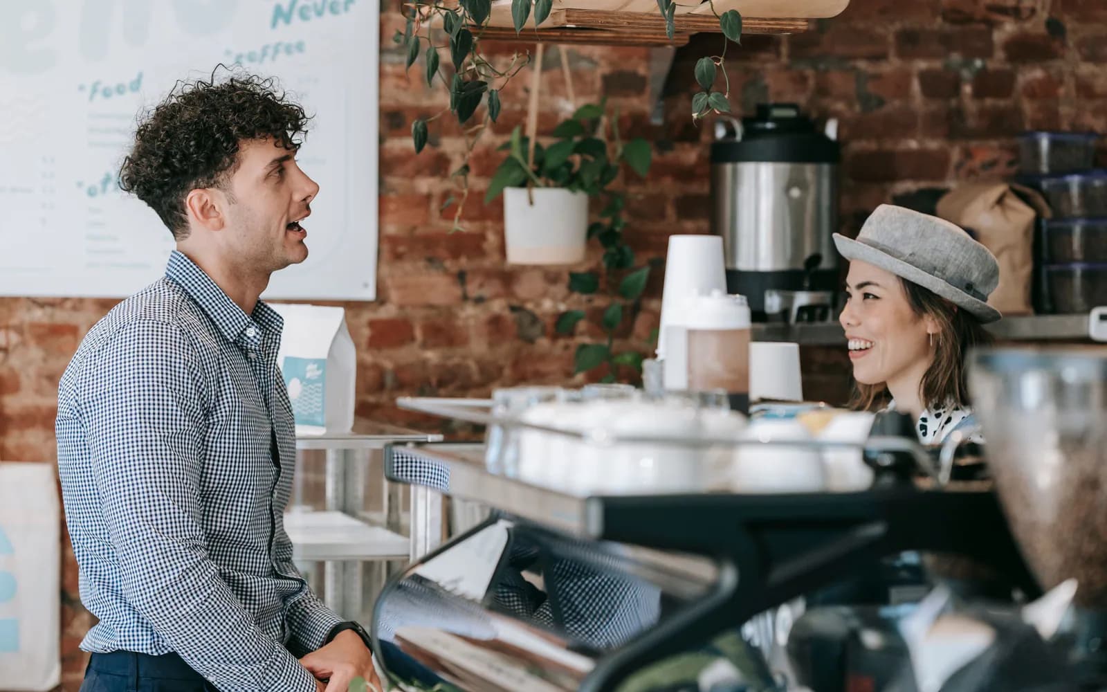 A restaurant owner greeting diners in a bright neighborhood restaurant