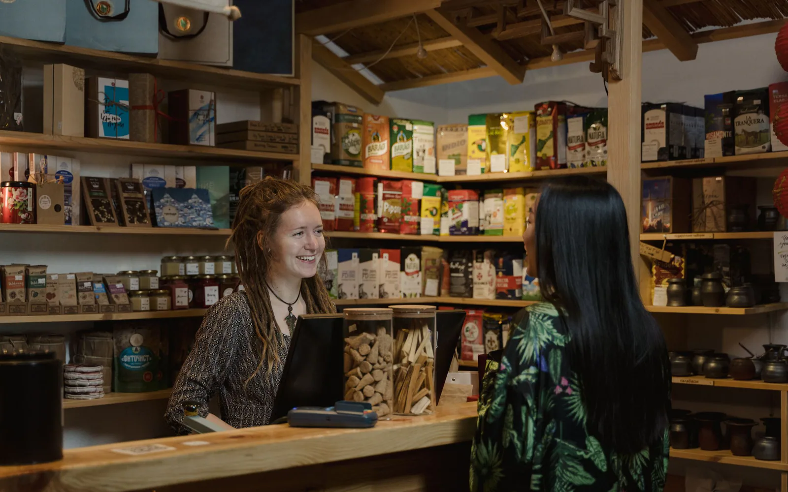 A local shopkeeper helping a customer at the counter