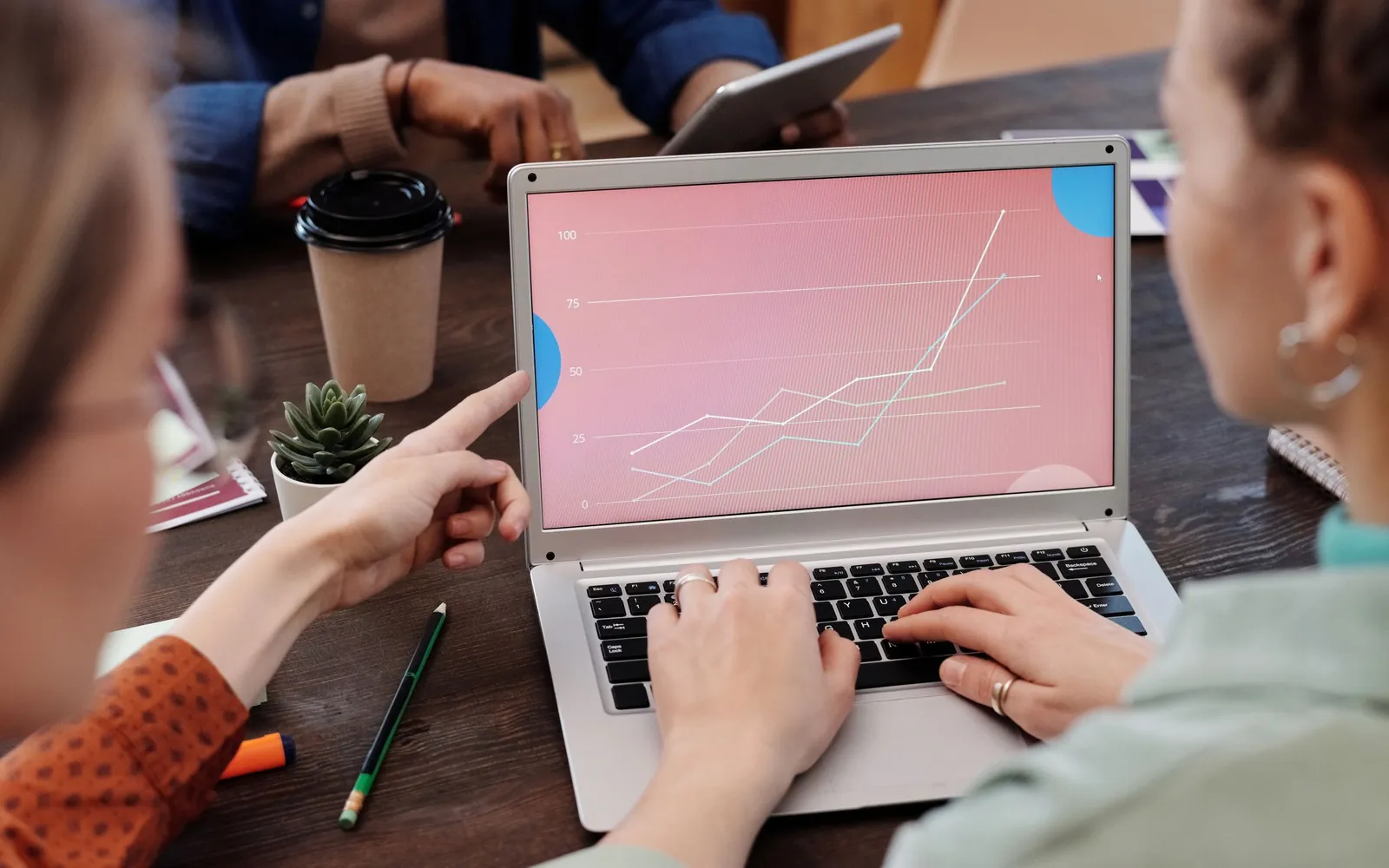 A team reviewing business trends together on a laptop