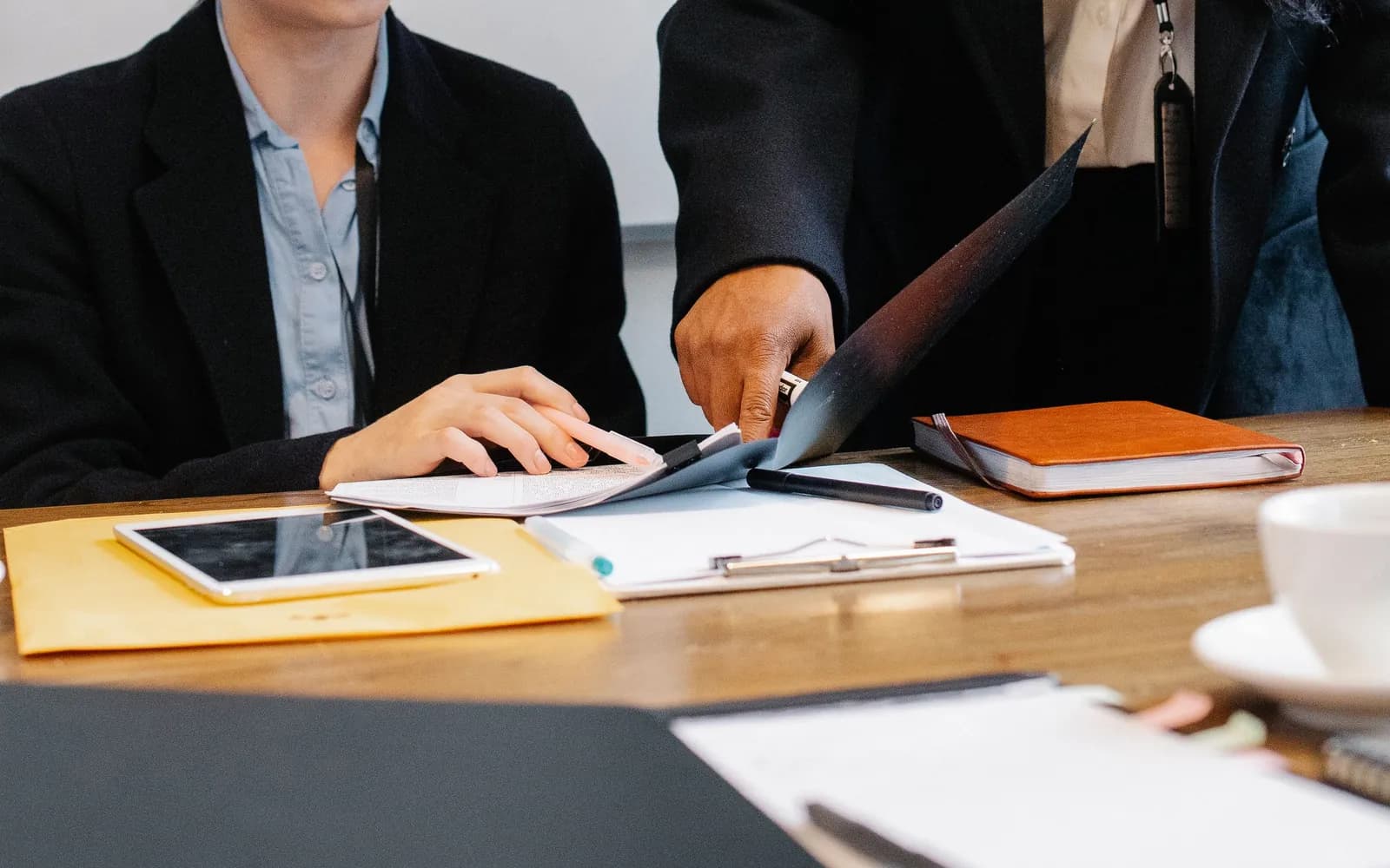 A diverse team collaborating around a computer in a bright office