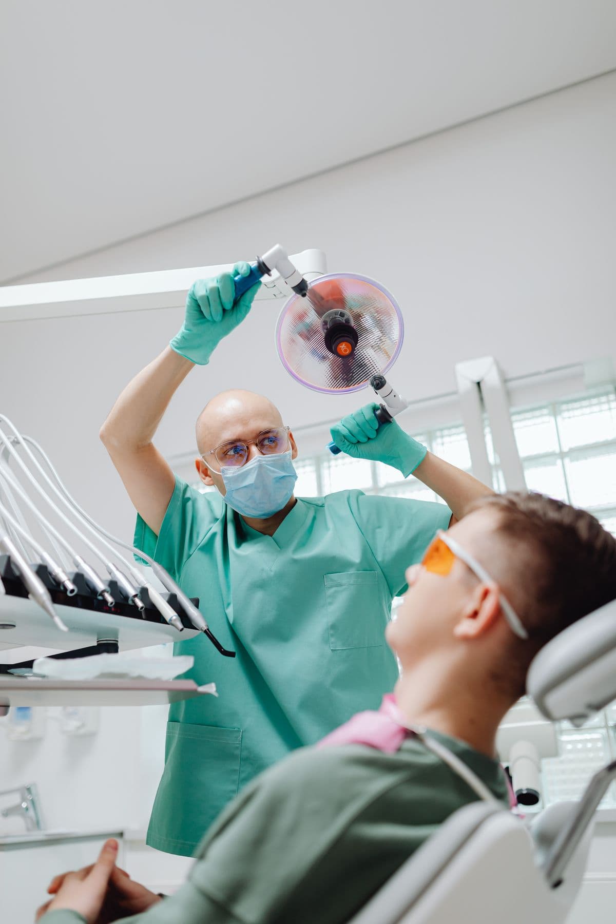 A dental reception team speaking with a visitor at the front desk