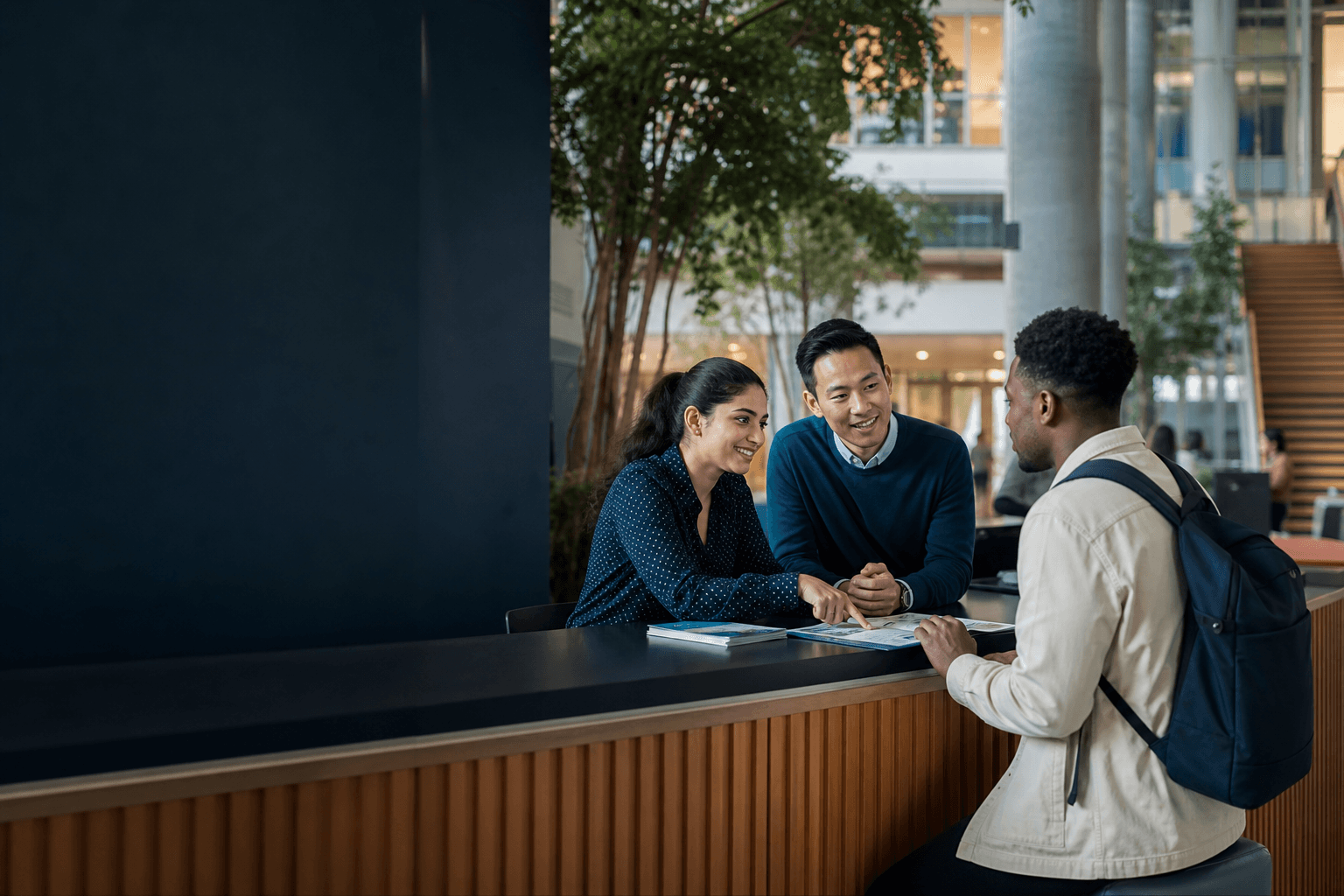A university support team helping an international prospective student