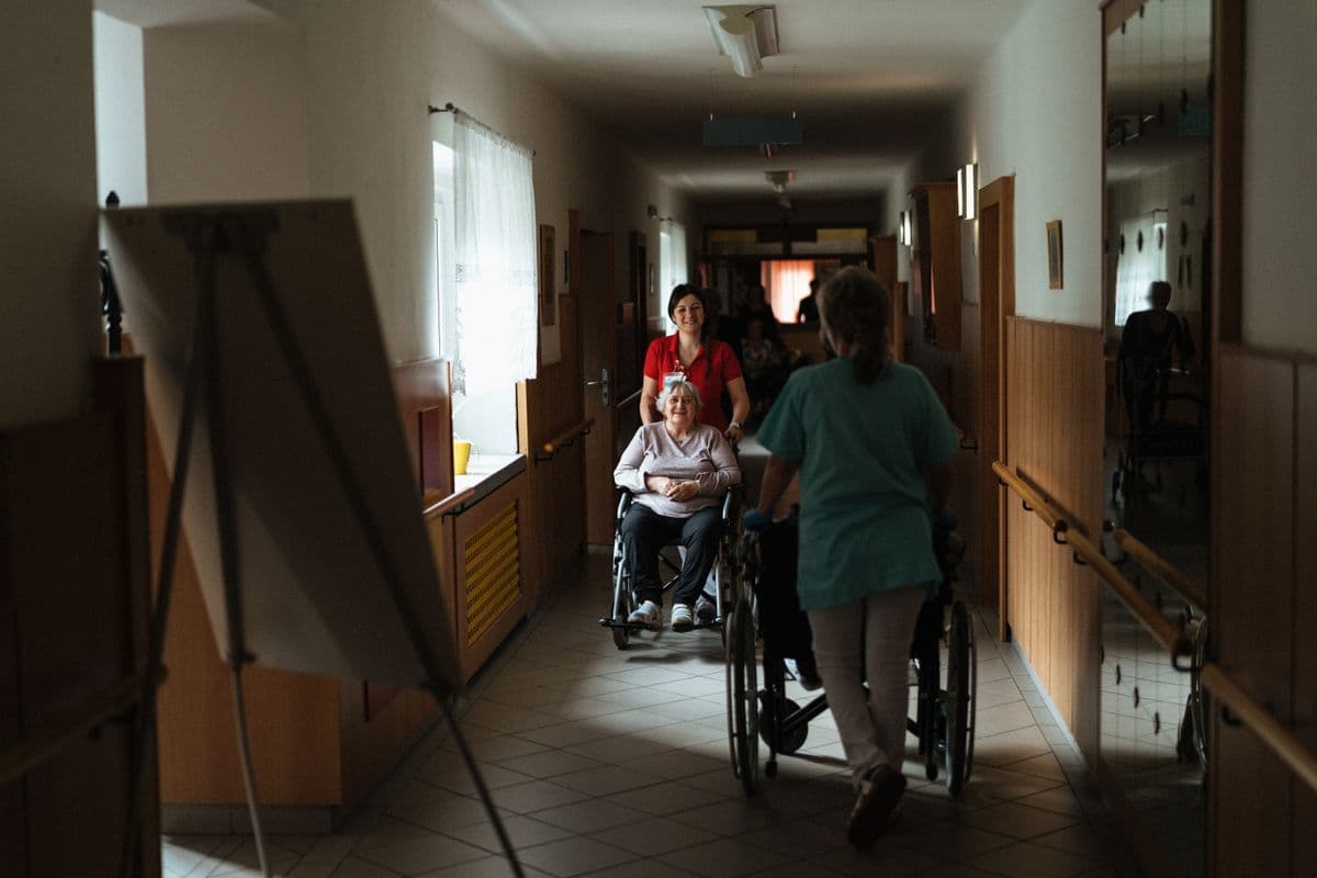 A care coordinator speaking with a family in a welcoming reception area