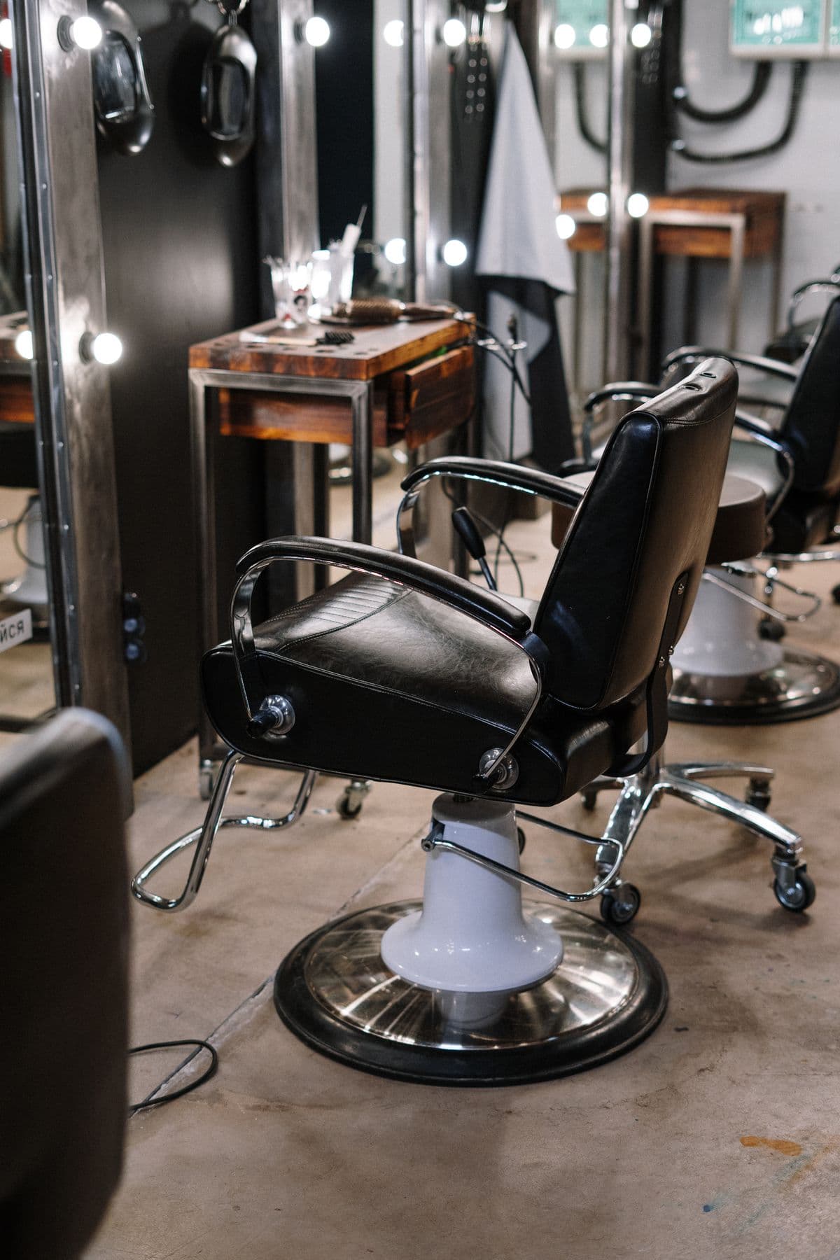 Salon chairs facing illuminated mirrors